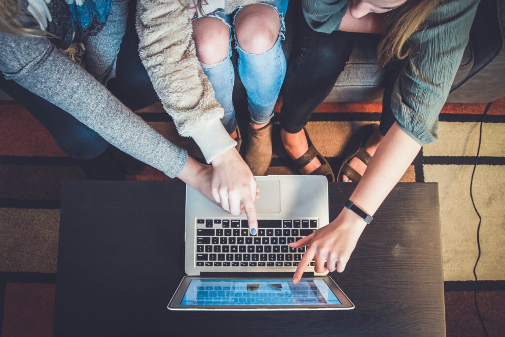 Influencer marketing screen caption girls pointing at screen in a room