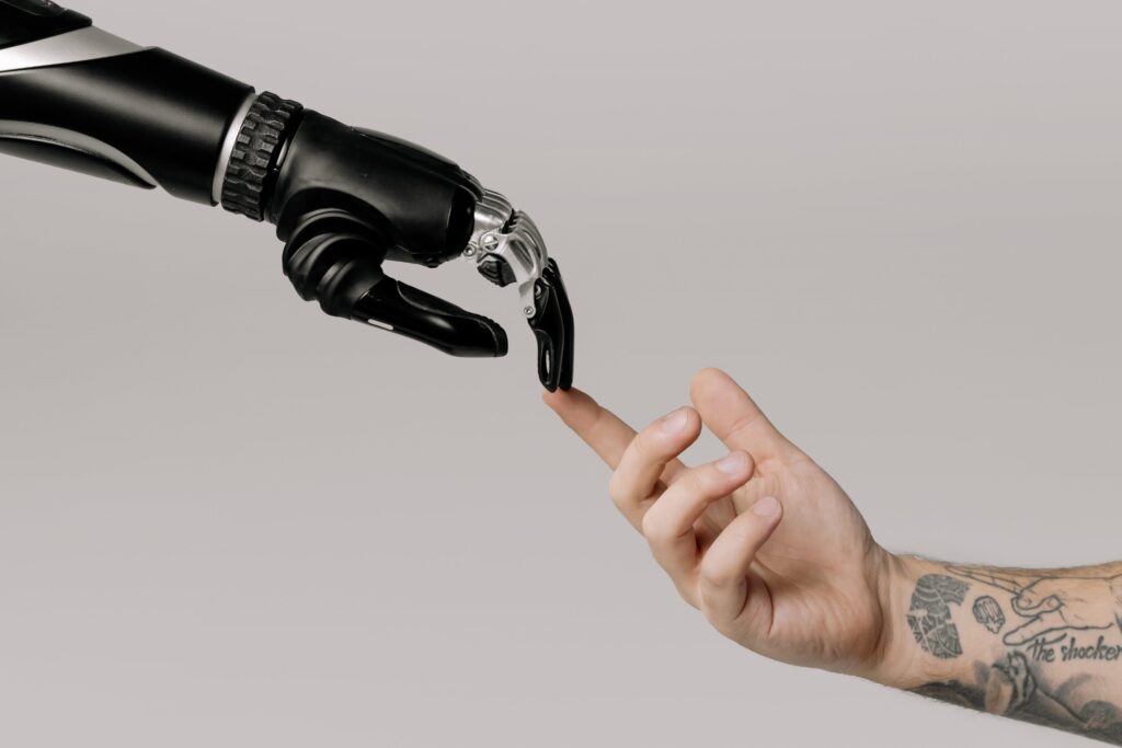 AI hand reaching for human hand with tattoos connecting fingers